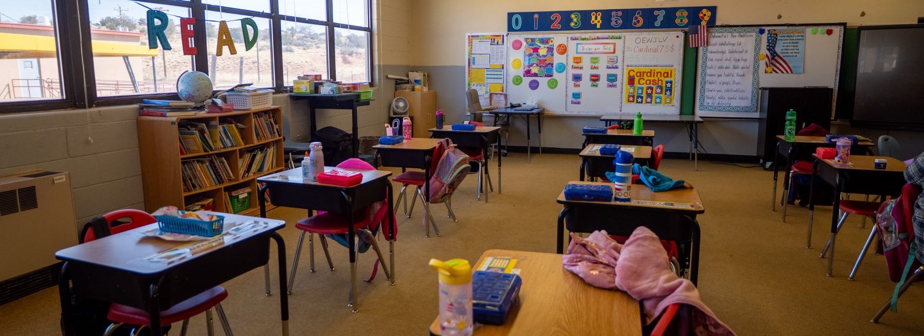 A bright classroom showcasing desks and chairs, prepared for students to gather and participate in lessons.